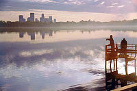 Downtown skyline in view over Lake Calhoun and its dock