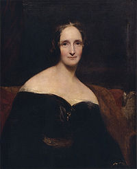 Half-length portrait of a woman wearing a black dress sitting on a red sofa. Her dress is off the shoulder, exposing her shoulders. The brush strokes are broad.