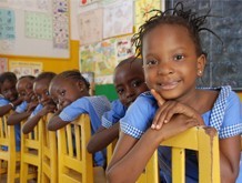 Sitting on yellow school chairs