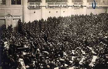 A large gathering of men sitting behind desks