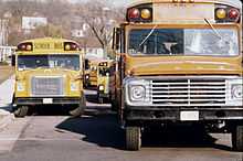 Two conventional school buses, from left to right: a Ward Volunteer with International Harvester chassis, and a Wayne conventional with Ford chassis, photographed in the mid-1970s.