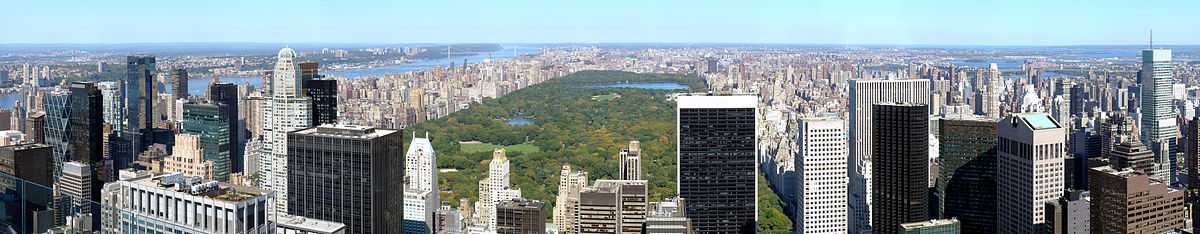 A large rectangular park stretches to the horizon behind a city skyline.