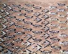 Aerial view of B-52s and other aircraft slowly being scrapped in the desert.