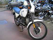 White BMW R100GS parked in front of some other motorcycles