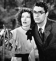 Katharine Hepburn and Cary Grant (in round glasses), looking off-screen