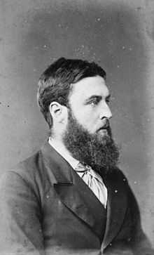 portrait of a bearded man in formal attire