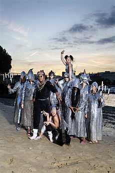 Chrome Hoof on a dawn/dusk Summer of 2007 river beach, dressed to promote 'Pre-Emptive False Rapture'.  Flanking members hold candelabra and most are wearing silvery cowls, with Leo Smee counterpointed in matt black.