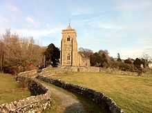 A stone church tower, on a sunny winter morning.