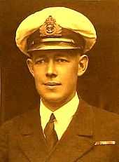 Formal head-and-shoulders portrait of young man in winter naval uniform with peaked cap