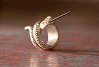 Gold serpentine ring with a protruding needle