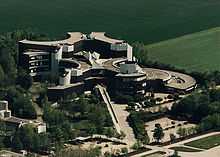 Aerial view of large, landscaped complex of buildings