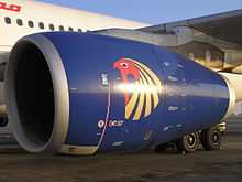 A mostly blue jet engine suspended on a wing; it is characterised by its smooth nacelle, or outer casing.