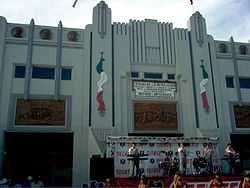 photo of main entrance with band and cheerleaders