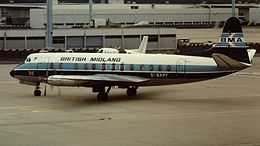 An aircraft pictured standing on the apron at an airport