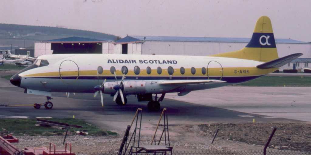 An aircraft pictured standing on the apron at an airport