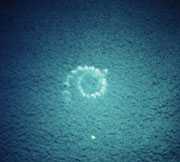 Aerial photo of bubbles forming a spiral at the surface