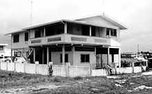 Black and white of a house situates in an empty field