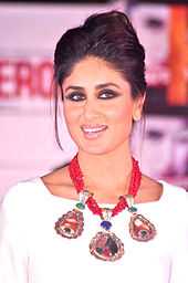 Kareena Kapoor clad in a white dress and a red necklace