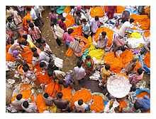 A road-side area where many people are involved in buying and selling of flower garlands