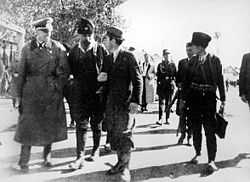 Pećanac walking alongside a German officer and a Kosovar Albanian collaborator