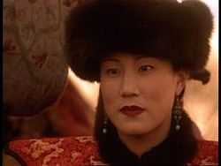 Headshot of a Chinese noblewoman dressed in red robes and a black fur hat.