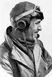 Head-and-shoulders profile of moustachioed man in leather flying helmet