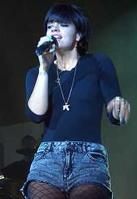 female singing into a microphone.