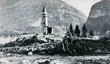 The bell tower of a church, standing above flood debris.