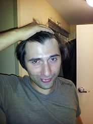 This photograph is of a young man with a widow's peak.