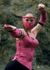 This image shows a masked woman with braided black hair, in a martial arts pose, wearing an a pink-and-black outfit.