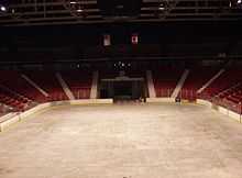 An empty arena with the sheet of ice and the score board