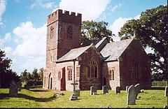 Red stone church with square tower.