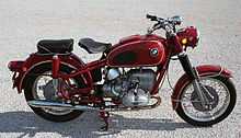 Red BMW R69US parked on a gravel/concrete surface