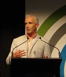 portrait photo of a man standing behind a lectern