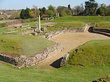 Roman theatre packed-earth entryway and central stage surrounded by grass-covered seating hillocks (ruins)