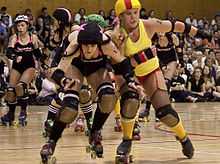 Roller derby skaters competing.