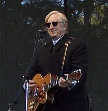 Burnett playing guitar onstage