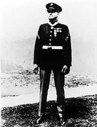 Full length portrait of standing man in circa 1930 U.S. Marine dress uniform.