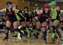 Roller derby skaters competing.