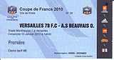 A blue football ticket stub with details of a match between FC Versailles and AS Beauvais. On the right hand side of the ticket is a dark strip with a number of sponsors' logos.