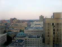 Skyline of several white and beige stone buildings and highrises