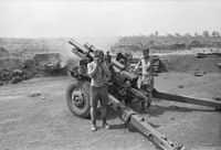 A black and white image of a New Zealand howitzer during Operation Coburg