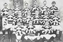 Photo of a group of rugby players posing in their uniforms.
