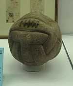 Another aged ball, slightly lighter in colour and more worn. Near the top are five vertical stitches