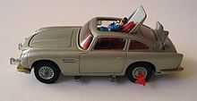 a silver-coloured toy car showing a plastic man being ejected through the roof.