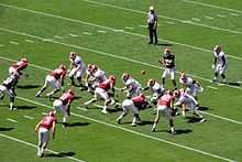 American football players in motion during a play.