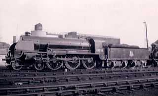 Side profile of a 4-6-0 locomotive on shed.