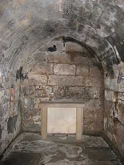 An underground stone lined crypt.