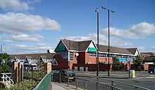 A 1980s medium sized supermarket building, viewed from across the Great North Road