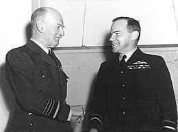 Informal half portrait of two smiling men in dark military uniforms